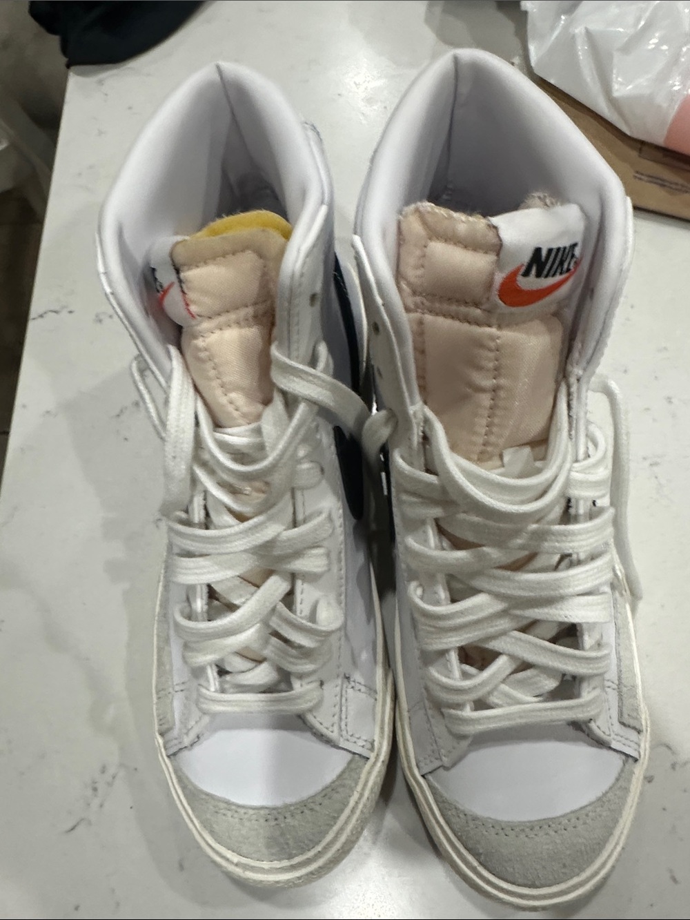 Nike White High-Top Sneakers with Orange Logo Accent
